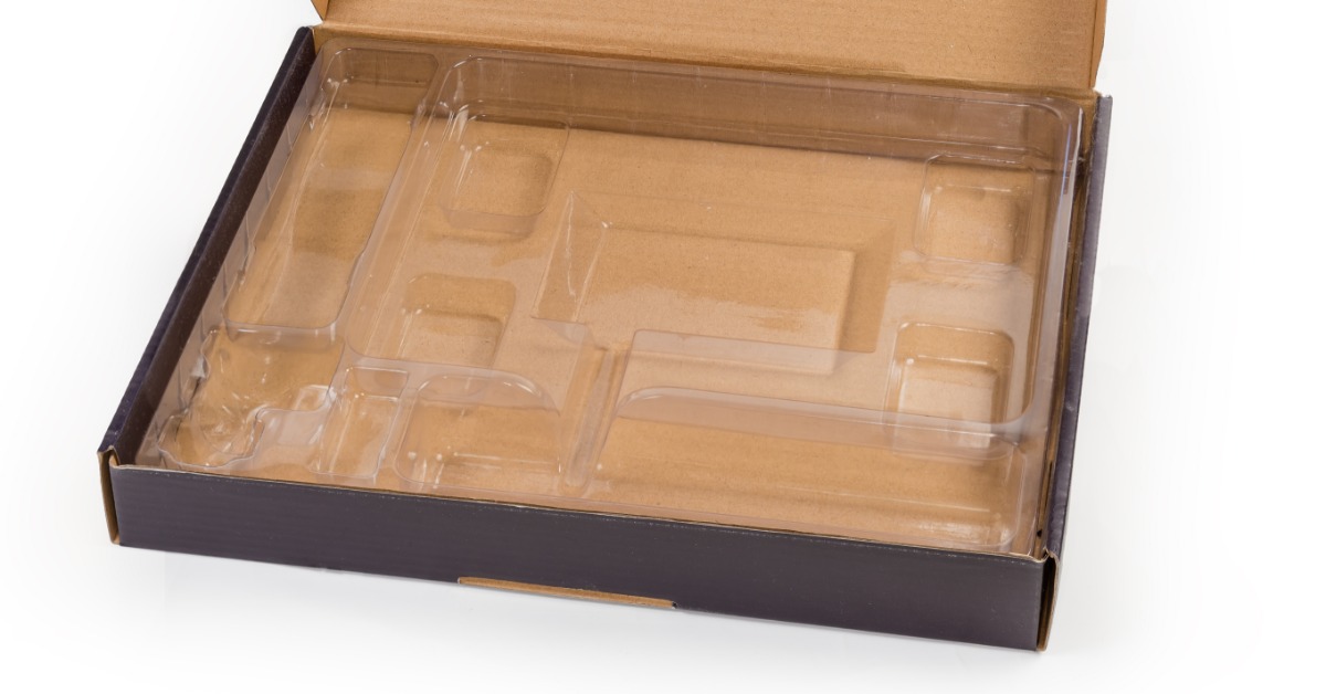 An open box that is black on the outside. Inside is a plastic thermoformed tray with multiple shaped inserts.