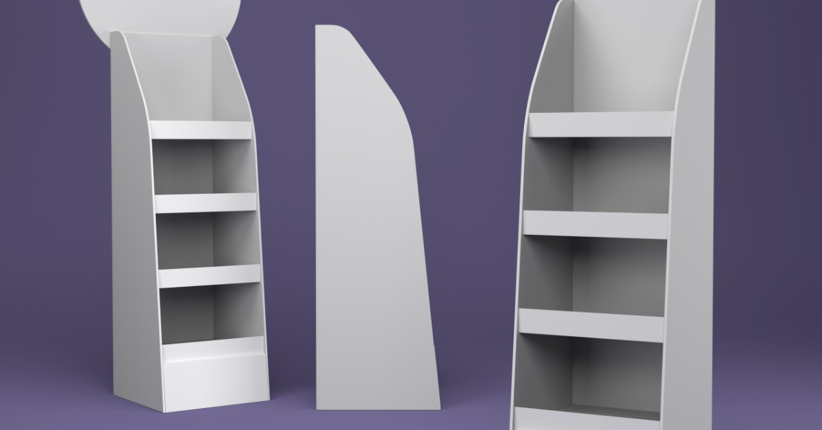 Three tall white cardboard display stands with shelves spaced evenly, placed in different positions next to each other.