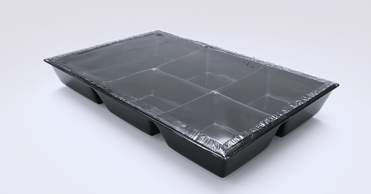 A black thermoformed tray with five cavities, sealed with a clear plastic film at the top of the package.